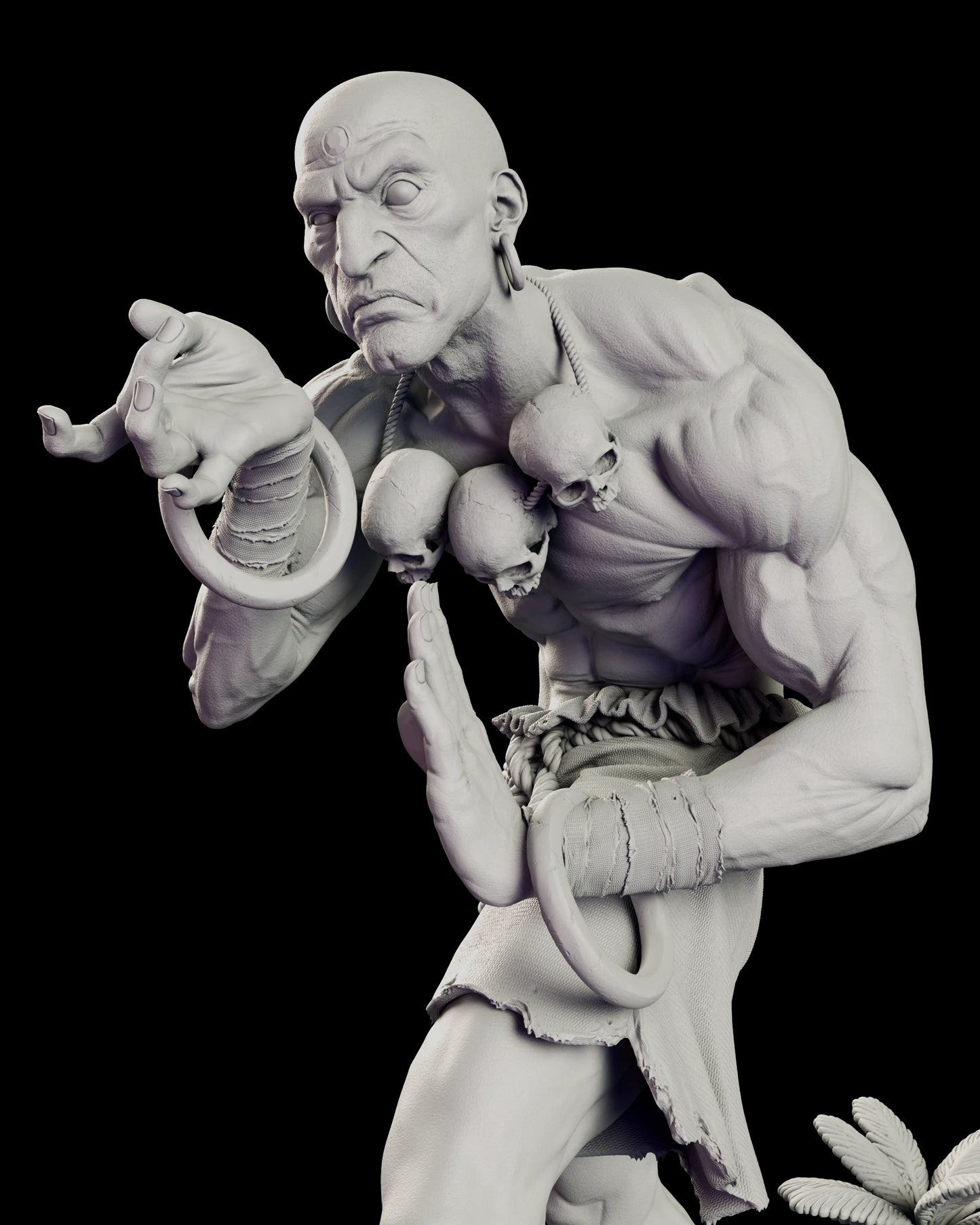 Close view of the upper body of the Dhalsim - Street Fighter figure model kit, showing the three cracked skulls on their knotted cord, the forearm bangles and frayed wrist bindings and the reaching hand