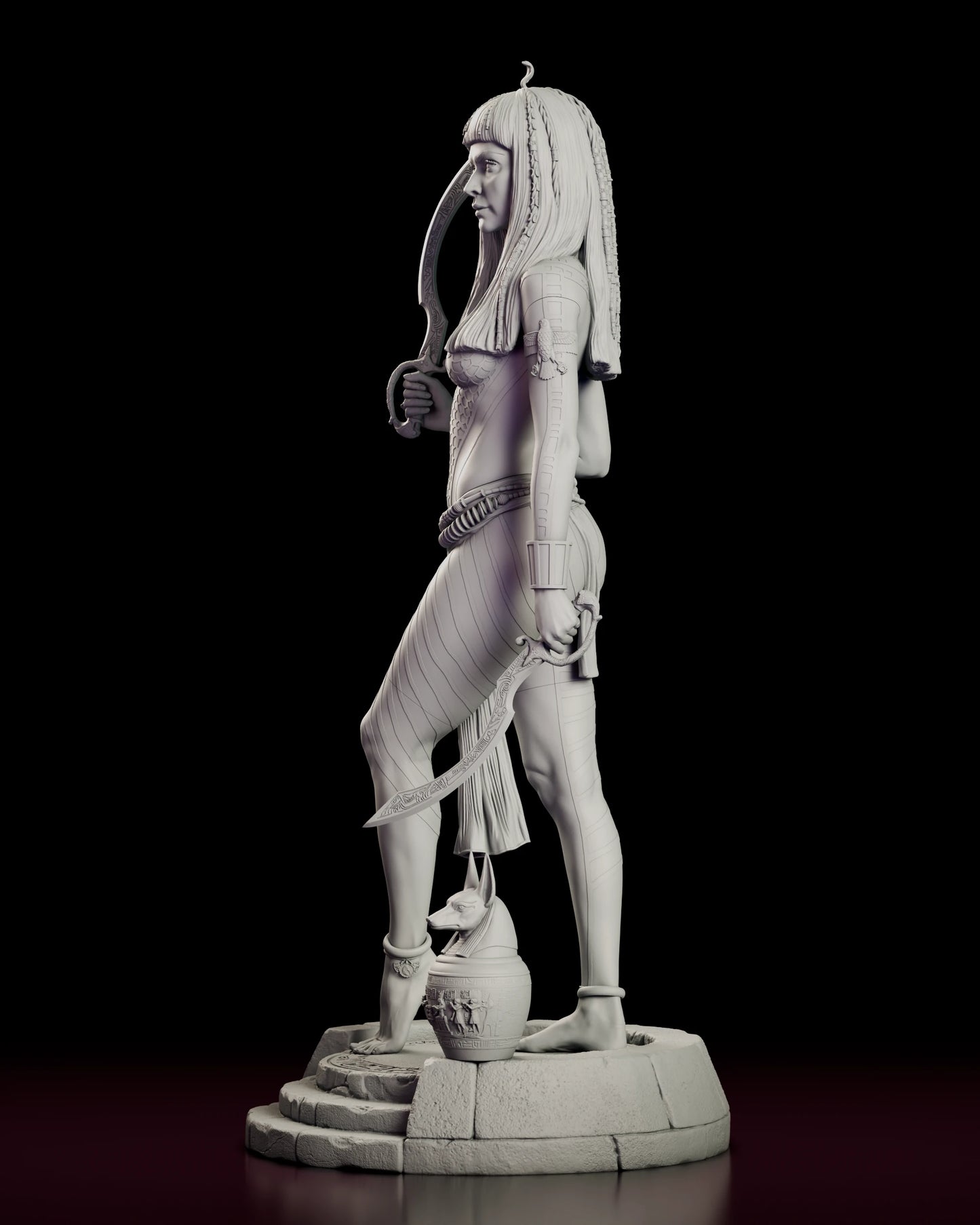 Left side view of the Anck-Su-Namun figure model kit showing the lowered blade, the split skirt and the canopic jar beside her feet