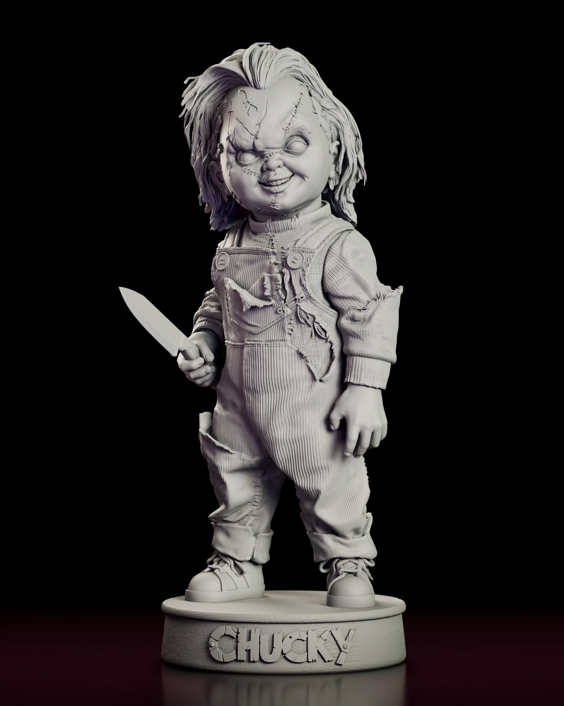 Front view of the Chucky figure model kit in torn overalls and knit sweater holding a kitchen knife