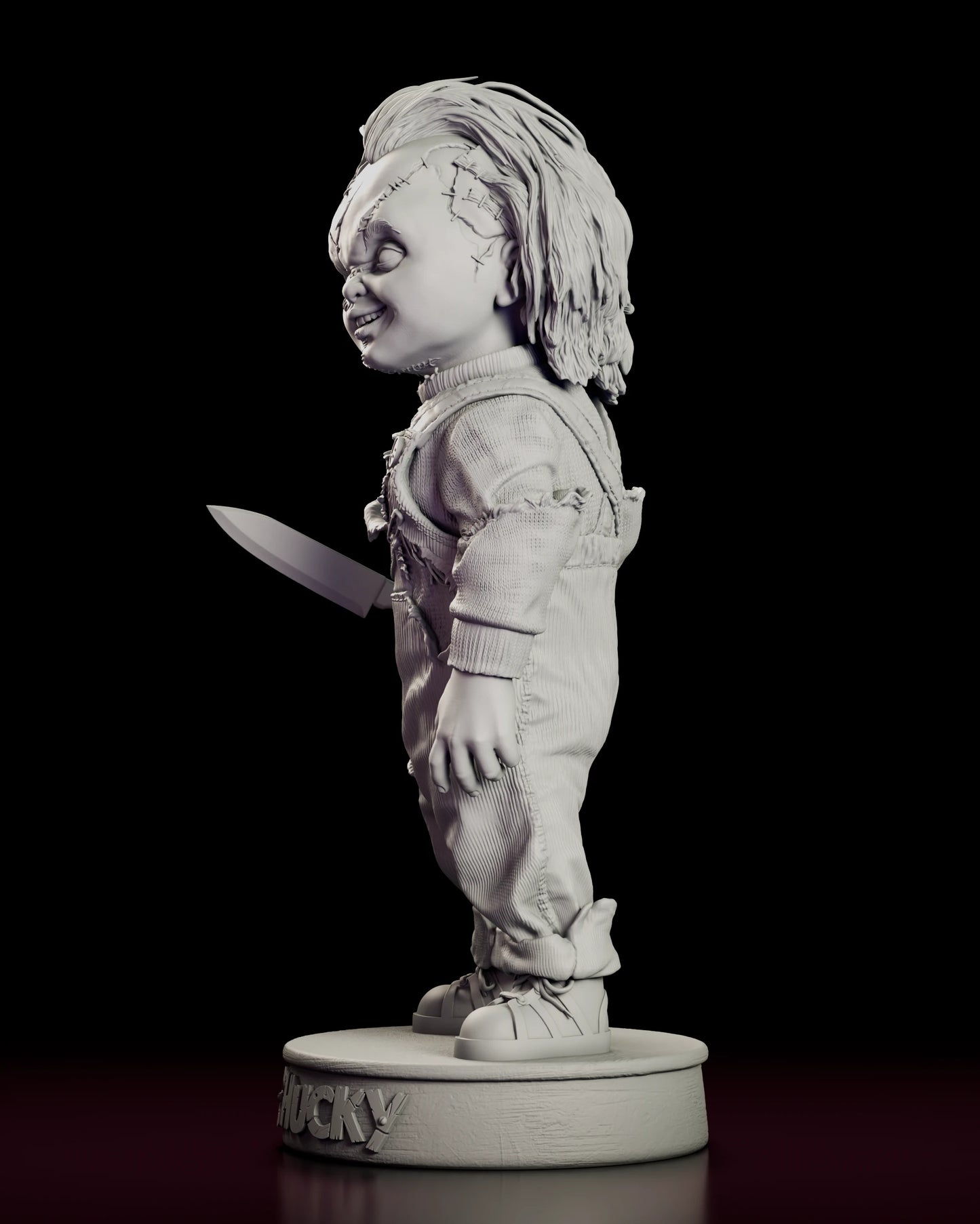 Left side view of the Chucky resin model showing the knife hand and the torn knee of the overalls