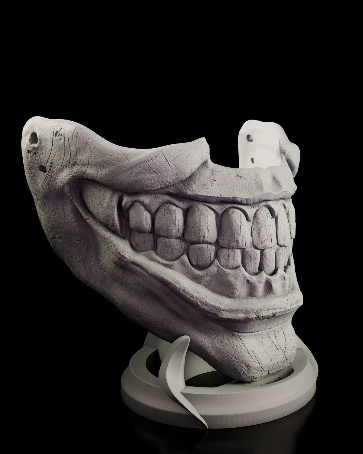 Close view of the Twisty mask from the other side showing the stretched grin and strap holes