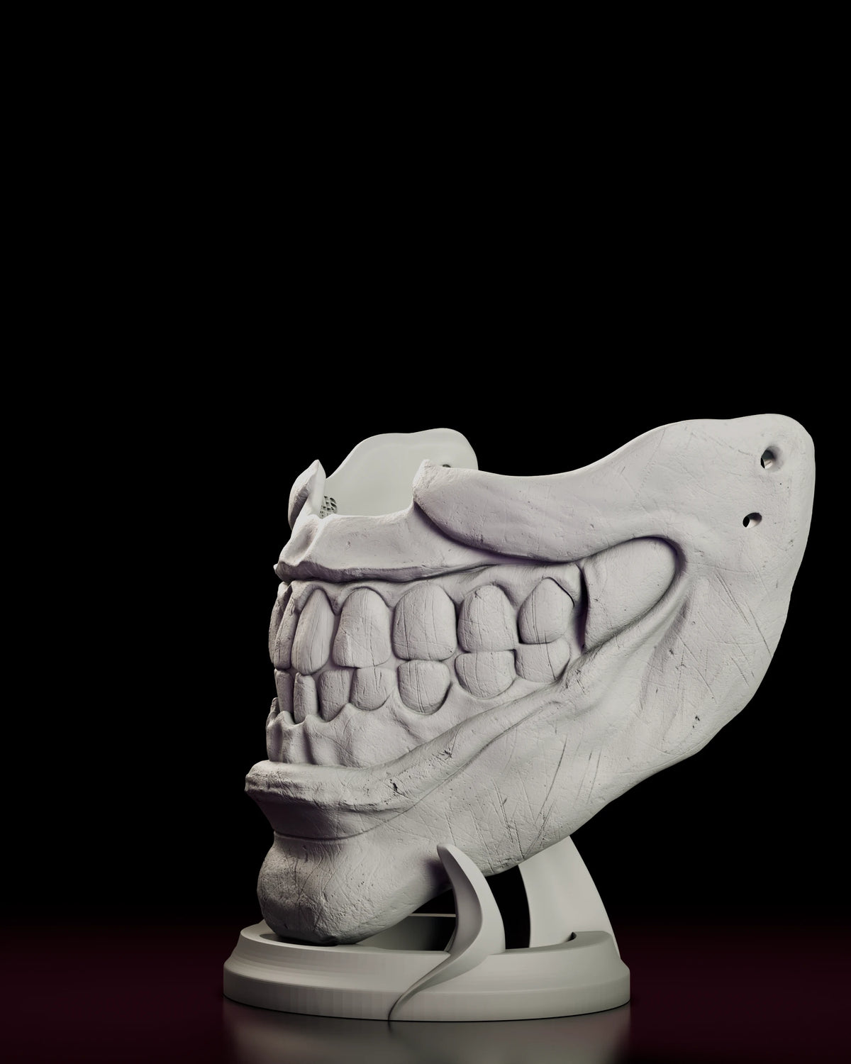 Left side view of the Twisty mask with the strap holes and curved stand