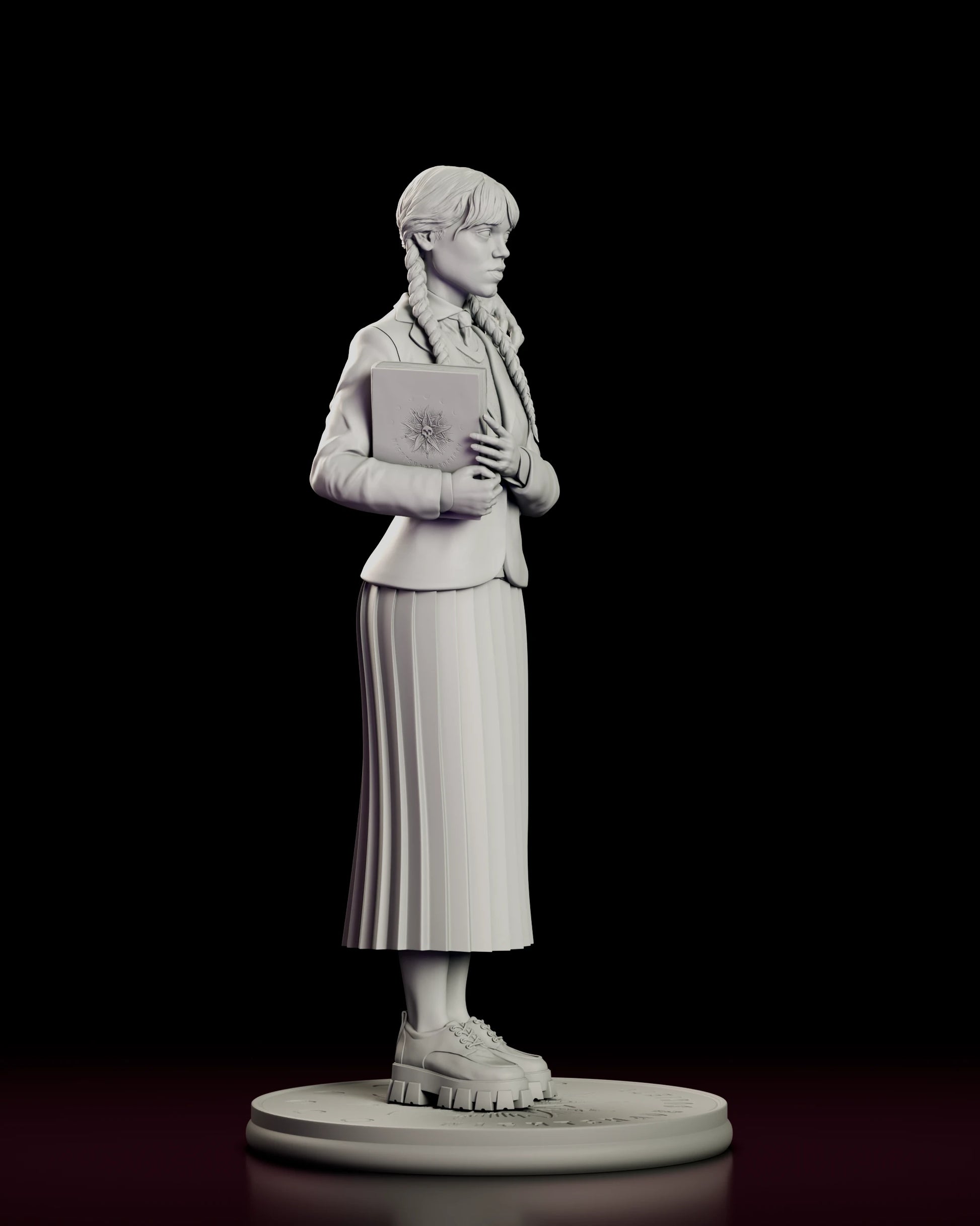 Right side view of the Wednesday Addams figure model kit showing the engraved sunburst and skull on the book cover, the cut of the blazer and the fall of the pleated skirt over lug-soled shoes